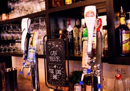 a bar with a counter with bottles of alcohol at Holiday Inn Alexandria - Downtown by IHG in Alexandria