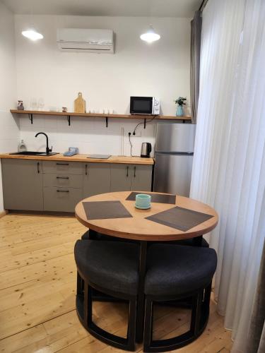 a kitchen with a wooden table and a table and chairs at Old Gold Anteon in Tbilisi City