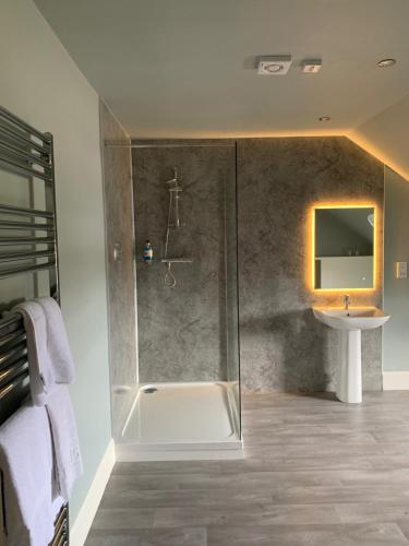 a bathroom with a shower and a sink at The Royal Hotel Elgin in Elgin