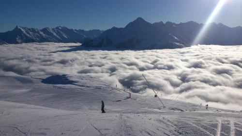 a person standing on top of a snow covered mountain at Landhaus Maria in Finkenberg