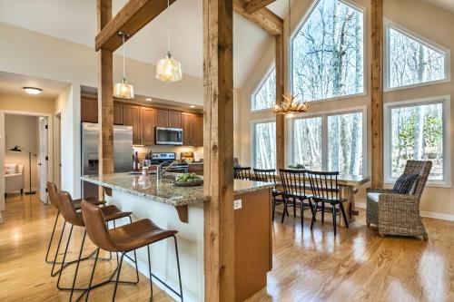 an open kitchen and living room with wooden beams at Designer Home with Fire Pit about 70 Steps to Slopes! in Wintergreen