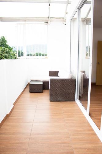 a living room with a couch and a wooden floor at Hotel Brisas De Calima in Cali