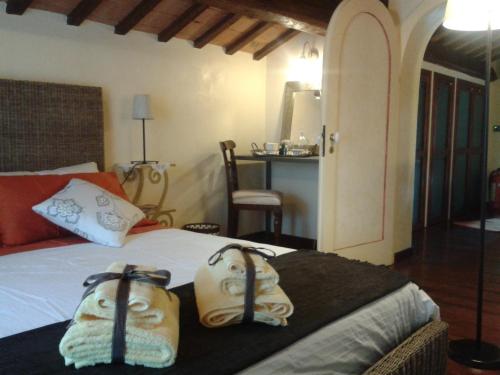 a bedroom with a bed with two bags on it at Armonia della Sera B&B and Relax in Porto SantʼElpidio