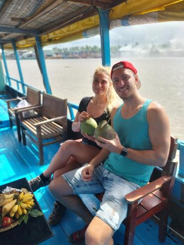 a man and a woman sitting on a boat at BenTrestay in Giồng Tú Ðiền