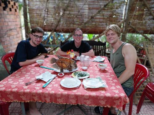 a group of three people sitting at a table with a table cloth at BenTrestay in Giồng Tú Ðiền
