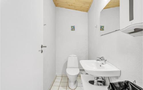 a white bathroom with a sink and a toilet at Pet Friendly Apartment In Strynø in Rudkøbing