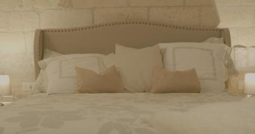 a bed with white sheets and pillows on it at B&B re apartments Palazzo Muscati in Molfetta