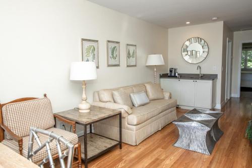 a living room with a couch and a table at Three Village Inn in Stony Brook