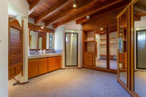 a large bathroom with wooden cabinets and a large mirror at Casa Ficus, serviced Luxury Villa with pool&tennis in Valle de Bravo