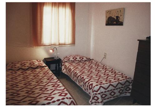 Postel nebo postele na pokoji v ubytování Mar De Cunit
