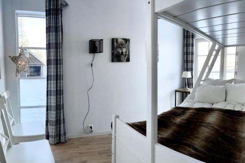 a bedroom with a canopy bed and a window at New apartment near the lifts tourist center Trysil in Trysil