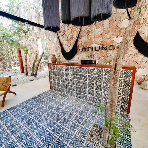 a room with a bed with a blue and white tiles at Oriundo Luxury Nature Villas in Valladolid