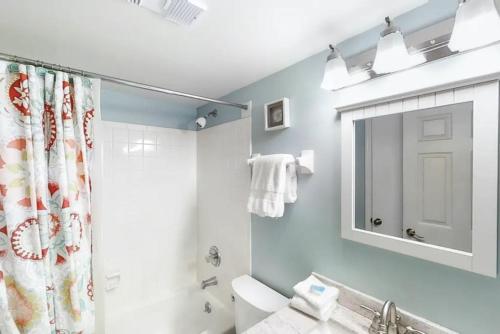 a bathroom with a shower and a toilet and a sink at 3118 Near Ocean 1st Floor SE in Saint Augustine Beach