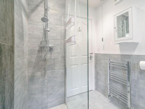 een douche met een glazen deur in de badkamer bij Kays in Cleveleys