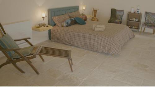 a bedroom with a bed with a chair and two towels at B&B re apartments Palazzo Muscati in Molfetta
