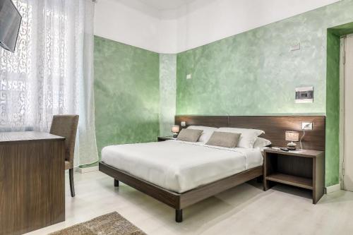 a bedroom with a bed and a desk and a bed sidx sidx sidx at ASSO RESIDENCE STAZIONE in Terni