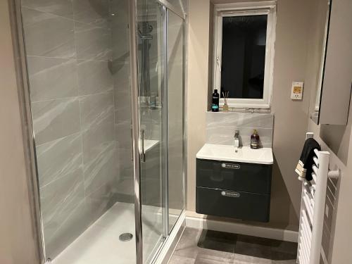a bathroom with a shower and a sink at Buckingham Court in St. Albans