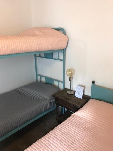 a room with two bunk beds and a table with a lamp at Hotel Rid in Mar del Plata