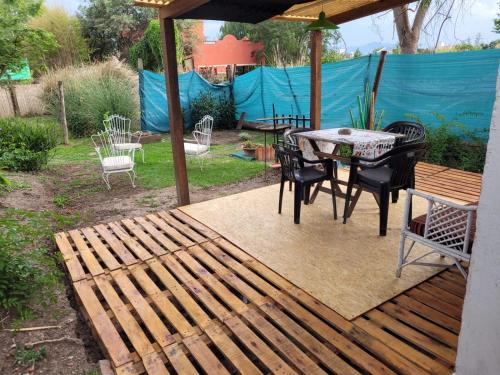 a wooden deck with a table and chairs on it at Mi casa in Salta