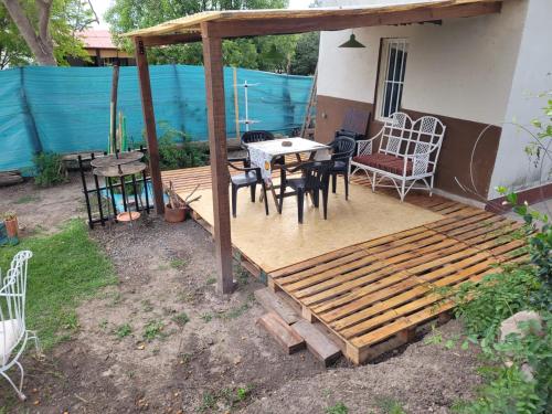 a patio with a table and chairs and a wooden deck at Mi casa in Salta