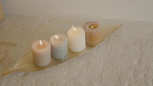 a group of candles on a plate on a table at B&B re apartments Palazzo Muscati in Molfetta