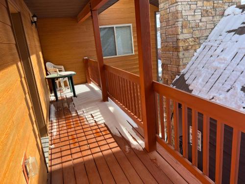 an empty porch of a house with snow on it at Faithful Street Inn in West Yellowstone