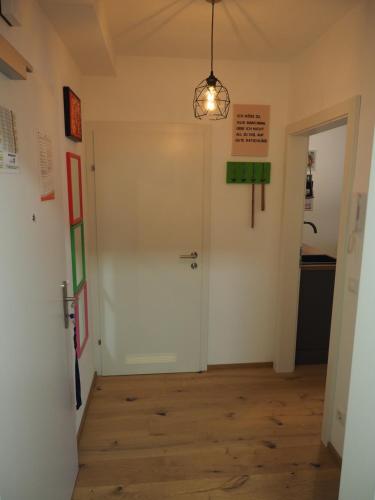 a hallway with a white door and a light fixture at Ahorn 4 in Gröbming