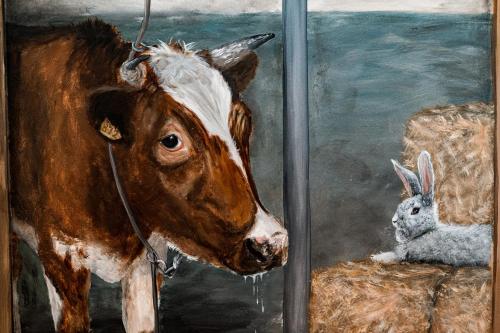 a painting of a cow and a rabbit at Landelijk gelegen vakantiewoning in Oldebroek