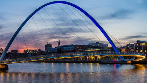 a bridge over a river with a city in the background at Staybridge Suites Newcastle by IHG in Newcastle upon Tyne