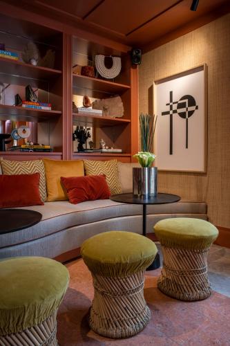a living room with a couch and two stools at Sublime Lisboa in Lisbon