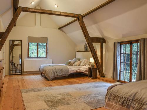 a bedroom with two beds in a attic at The Barn in Chipperfield