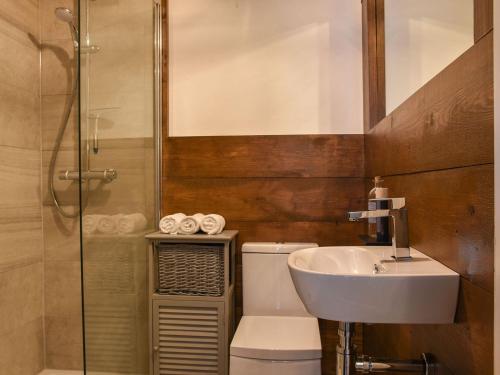 a bathroom with a sink and a toilet and a shower at The Barn in Chipperfield