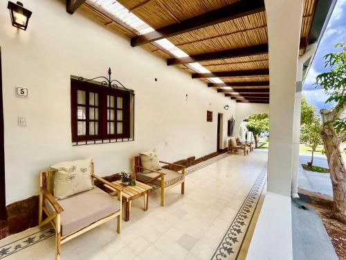an outdoor patio with couches and a wooden ceiling at Bella Tilcara Boutique Hotel in Tilcara
