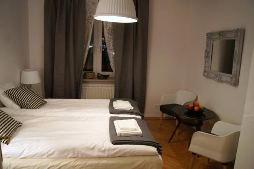 a bedroom with a bed with two towels on it at Apartament Daszyńskiego in Krakow
