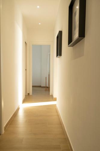 an empty hallway with white walls and wood floors at Noliday Riviera Sea View Luxury Apartment in Noli