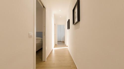 a hallway of a house with white walls and wooden floors at Noliday Riviera Sea View Luxury Apartment in Noli