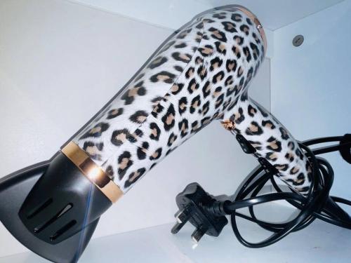 a leopard print microphone on a white table at Newly refurbished 3 bedroom entire terraced house in Lincolnshire