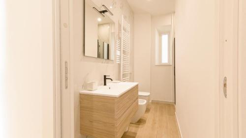 a white bathroom with a sink and a toilet at Noliday Riviera Sea View Luxury Apartment in Noli
