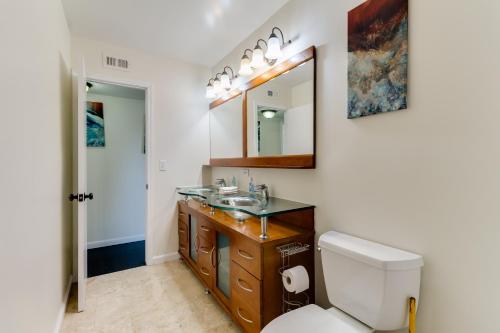 a bathroom with a sink and a toilet and a mirror at 5 Bedroom Charmer in Granada Hills in Granada Hills