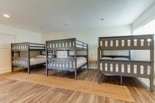 three bunk beds in a room with wooden floors at 5 Bedroom Charmer in Granada Hills in Granada Hills