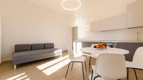 a kitchen and living room with a table and a couch at Noliday Riviera Sea View Luxury Apartment in Noli