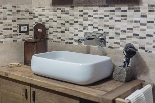 a bathroom sink with a faucet on a counter at Domus Antica Aosta in Aosta