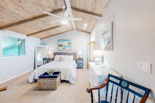 a bedroom with a white bed and a wooden ceiling at Ocean Pacific Neptune C in Oceanside