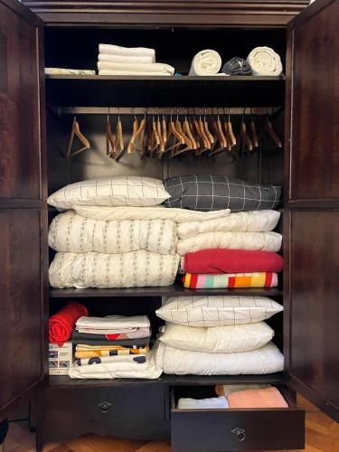 a closet filled with lots of pillows and towels at Apartments Gozdni Raj Rogla in Oplotnica