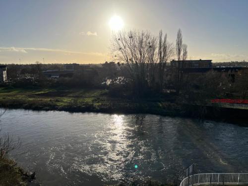 a view of a river with the sun in the sky at Riverside Apartment Chelmsford in Chelmsford
