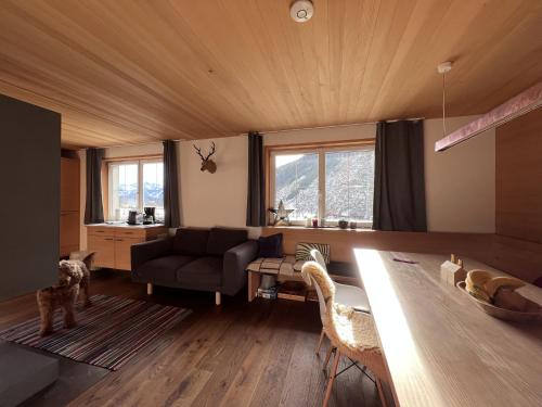 a living room with a couch and a table at Alpenrose Boutique Chalet Gretl in Ramsau am Dachstein