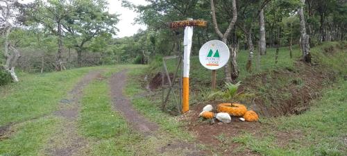 a group of stuffed animals sitting next to a sign at Pochote Lodge in Hacienda Guayabo