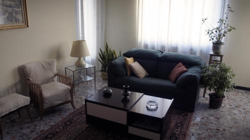 a living room with a couch and a coffee table at Il Piccione Viaggiatore in Banchette