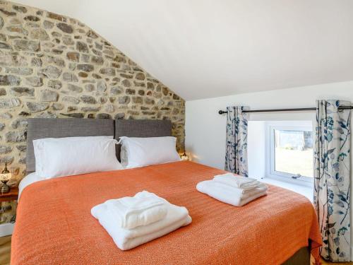 a bedroom with a bed with two towels on it at The Hayloft - Uk40092 in Bryngwyn