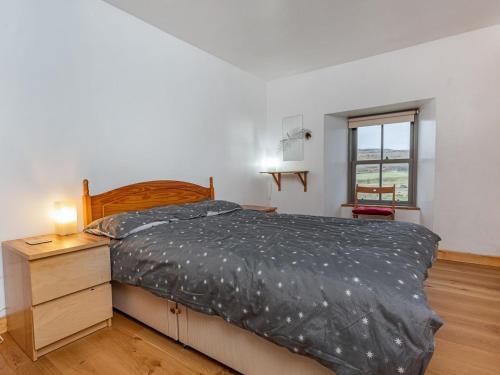 a bedroom with a bed and a dresser and a window at Herons Rest in Glendale